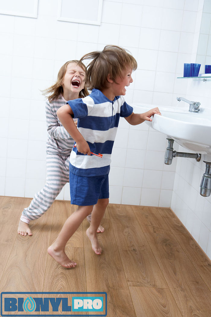 Boy And Girl In Bathroom Brushing Teeth